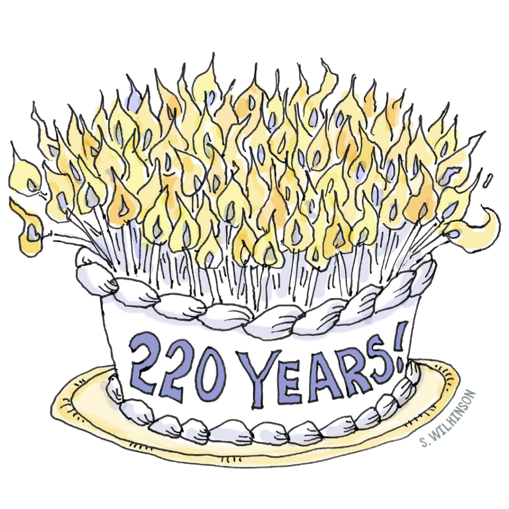 A cartoon of a birthday cake. It says 220 Years on the side. It has lit candles on top, though not 220.