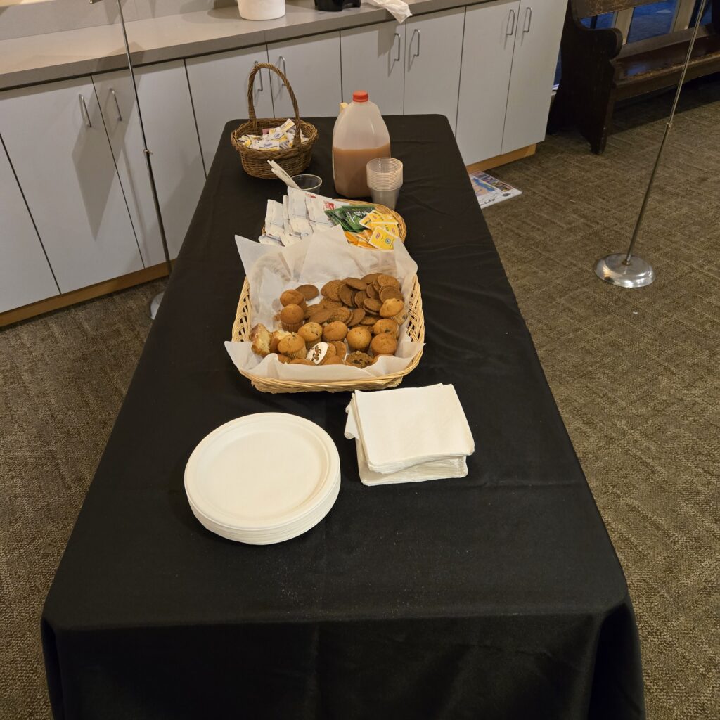 A table has a basket with a few sweet treats in it. Bring Your Own Mug Day is almost over.