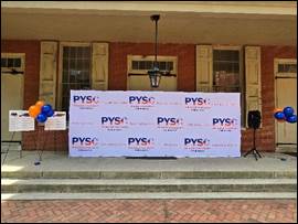 A banner says PYSC on the porch of the Race Street Quaker Meetinghouse.