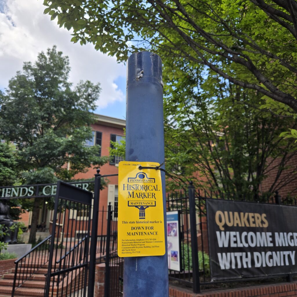 Blue pole with no sign on top. A yellow tag is attached.